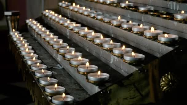 Rows of burning lit candles in Catholic Cathedral. Candles In church — Αρχείο Βίντεο