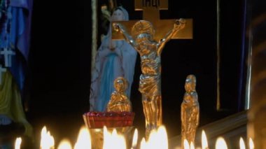 Many candles and cross in a dark background. Burning candles in the Christian Orthodox Church