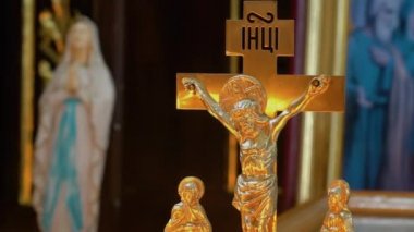 The crucifix is beautifully lit with candles in an Orthodox church