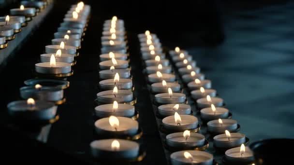 Rows of burning lit candles in Catholic Cathedral. Candles In church — Stock Video