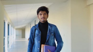Indian student with a books in the university or college. New modern fully functional education facility. Education concept