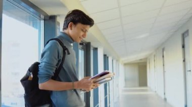 Indian student with a books in the university or college. New modern fully functional education facility. Education concept