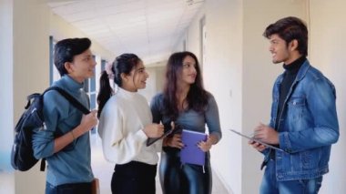 A group of Indian students with books and a tablet at the university or college. New modern fully functional educational institution. Education concept