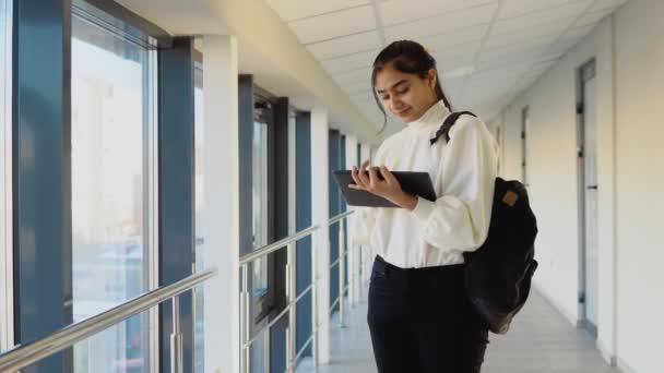 Pakistani woman student with a tablet in the university. New modern fully functional education facility. Education abroad – stockvideo