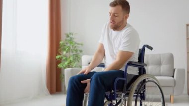 Üzgün engelli adam tekerlekli sandalyeye binmekte zorlanıyor