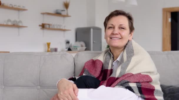 Portrait of a senior woman sitting on a sofa — Stock Video