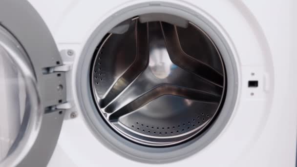 The male hand puts medical masks in washing machine. Washing machine loading — Stock Video