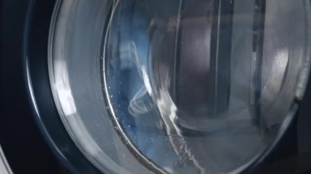 Washing machine washes dirty medical masks. Close up video of spinning drum washing machine — Stock Video