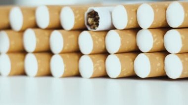 Bir yığın tütün sigarası beyaz arka planda döner.