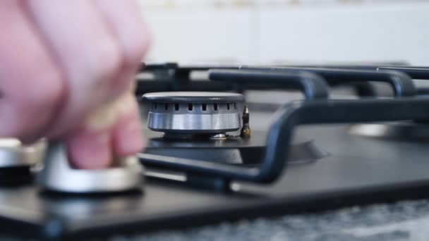 Close up of turning on gas stove top and putting a pot on it — Vídeos de Stock