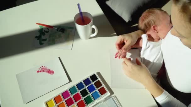 Mamma gör fingeravtryck på en liten flicka. — Stockvideo