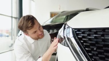 A man examine vehicle before making purchase. Buy car
