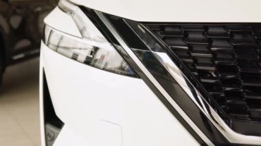Close up of details of headlights of anonymous prestigious white luxury modern car. Shot in 4K. Head light