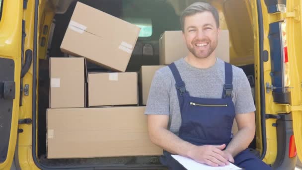 Courier with clipboard near delivery van outdoors. Delivery of medicines and products — Stockvideo