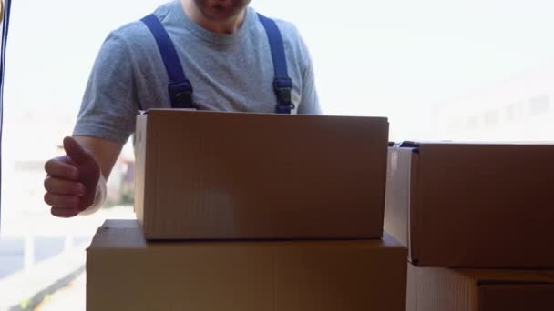 Delivery man unloads his cargo van prepare to send to customers — Video
