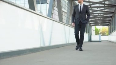 Confident guy in suit being on his way to work. Cityscape background