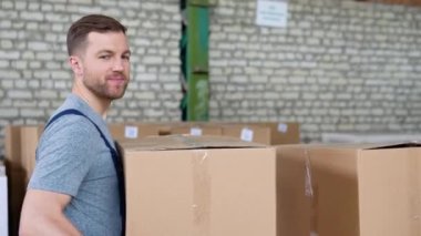 Depo çalışanı, raftan karton kutular ve paketler alarak sipariş topluyor.
