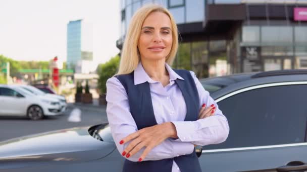 ビジネスセンターの背景を背景に 車の近くに立つ自信に満ちた女性の肖像画 — ストック動画