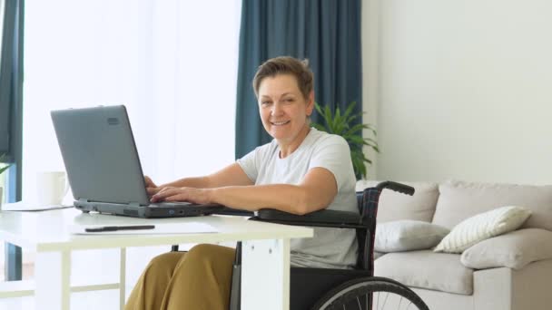 Freelancer Sênior Está Trabalhando Digitando Laptop Sentado Cadeira Rodas Casa — Vídeo de Stock