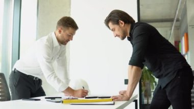 Two civil engineer or architect handshaking after mega project done