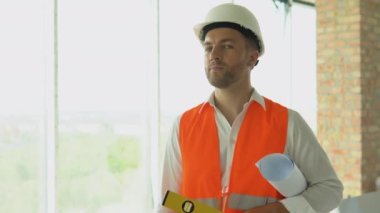 Engineer developer in helmet inspecting building. Builder constructor specialist. Civil engineer architect construction site