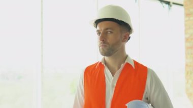 Engineer developer in helmet inspecting building. Builder constructor specialist. Civil engineer architect construction site