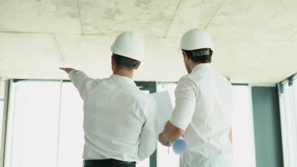 Young Engineers Safety Helmets Standing Construction Building Holding Blueprint Structure — 비디오