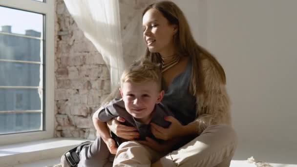 Little Boy Gently Hugs Mom Home Window Slow Motion — Vídeo de stock