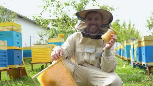 Closeup Portrait Beekeeper Holding Honeycomb Frame Jar Honey Beekeeping Concept — Video