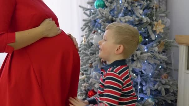Pregnant Mom Gently Hugs Funny Little Son — Stockvideo