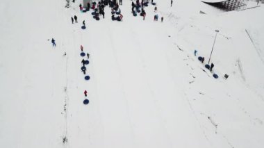 People ride on snow tube
