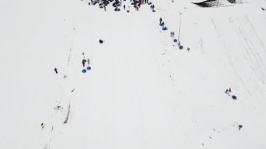 People ride on snow tube. Snow tube resort