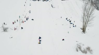 People ride on snow tube. Snow tube resort
