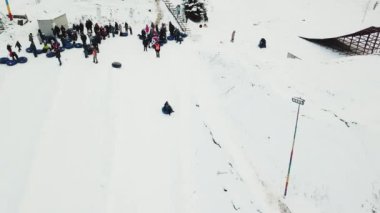 People ride on snow tube. Snow tube resort