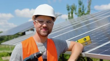 Portrait of confident engineer with screwdriver of solar cell farm industry