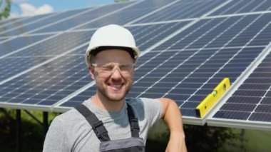 Portrait of confident engineer of solar cell farm industry. Staff confident pose Solar cell panel installation