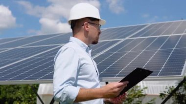 Engineers checking solar panels. Alternative energy ecological concept