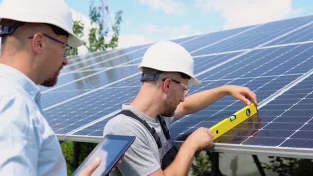Two Workers Helmets Check Installed Solar Panels Green Electricity Concept — Stock video