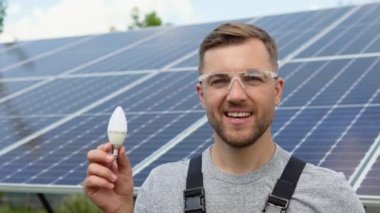 Engineer standing with lamp on solar panel and feeling freedom at view point. Electrician working on checking and maintenance equipment at industry solar power.