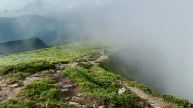 Man walks along the mountains to the top. Travel concept active people on the way to victory move forward close up.