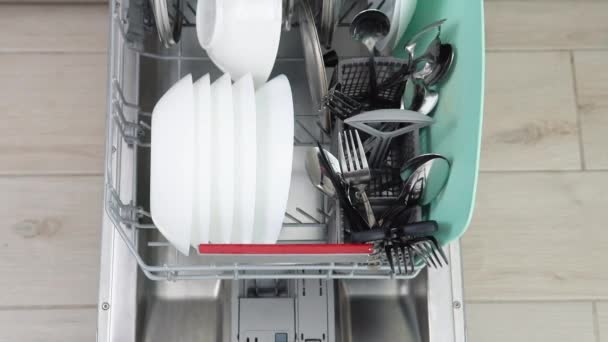 Young Man Loading Dirty Dishes Dishwasher Machine Man Uses Modern — Stock video