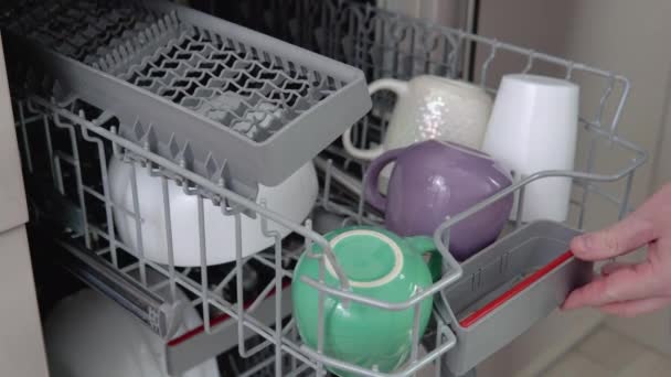 Young Man Loading Dirty Dishes Dishwasher Machine Man Uses Modern — Vídeo de Stock