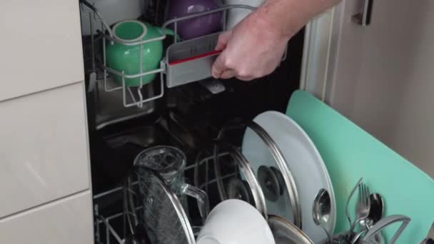 Young Man Loading Dirty Dishes Dishwasher Machine Man Uses Modern — Stockvideo