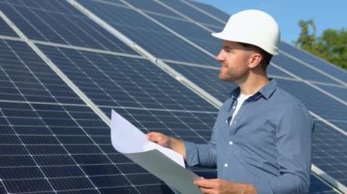 Engineers checking solar panels. Alternative energy ecological concept.