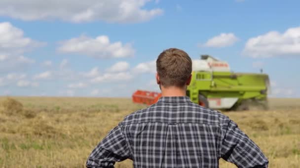 Portrait Young Farmer Looking Combine Working Field Corn Turning His — 图库视频影像