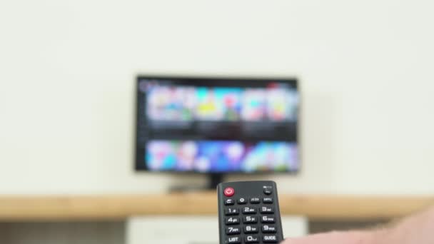 Mans Hand Selects Internet Channels Remote Control Close Person Controls — 图库视频影像