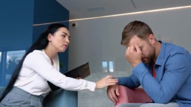 Female psychologist making note while patient talking.