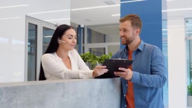 Woman reception consultant helps the client