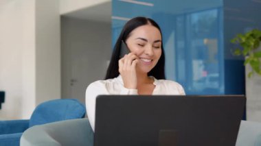 Young business girl working with laptop in coffee shop cafe.