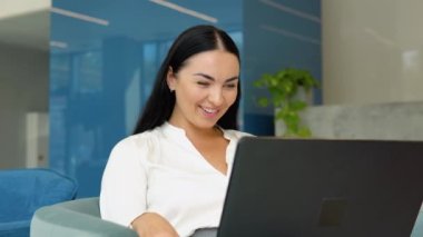 Freelance business woman using tablet working call video conference with customer in workplace at cafe